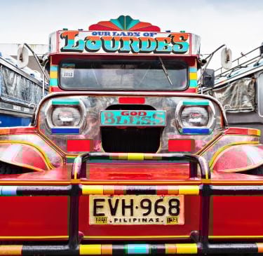 a truck with a colorful painted truck on it