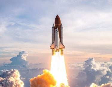 a space shuttle rocket ship launching into the sky