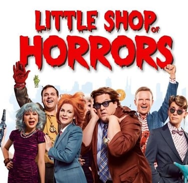 a group of people standing in front of a poster with the sign “little horrors”