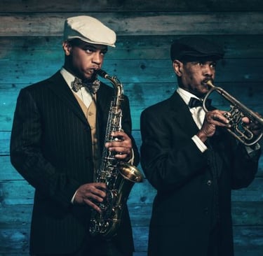 a man in a suit and hat playing the saxophone