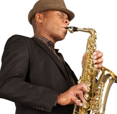 a man in a suit and hat playing the saxophone