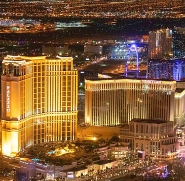 Aerial night view of the illuminated Palazzo and Venetian hotel resorts on the Las Vegas Strip.