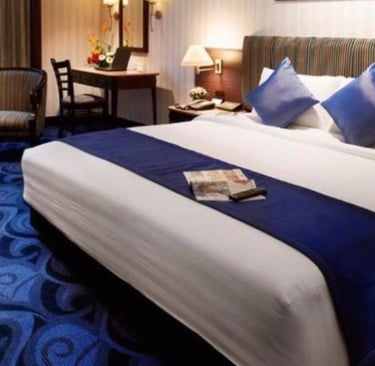 a hotel room with a bed and a chair