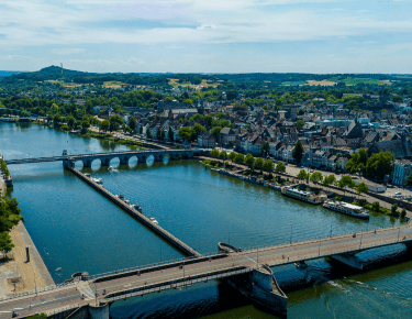 a bridge over a river with a bridge over it in maastricht, the netherlands
