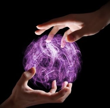 magic - two hands holding a purple ball with a purple ball