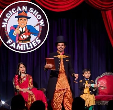 a performing magician on stage with help of a child and a woman