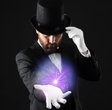a man in a tuxedo hat and gloves holding a magic wand