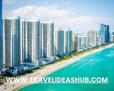 a beach with a view of the ocean and buildings