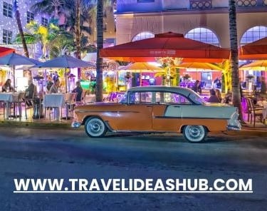 a car parked in front of a building with a red umbrella
