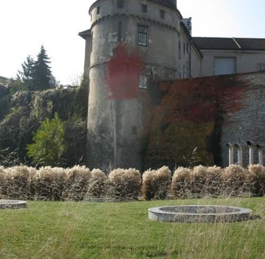 Historic stone castle tower with red autumn ivy and ornamental garden in Middelburg