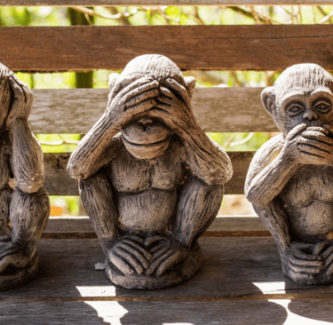 three wise monkeys sitting on a bench with their hands on their chins