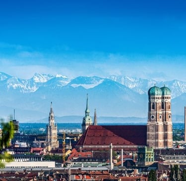 a city skyline with mountains in the background