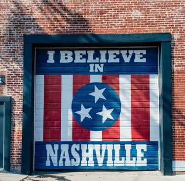 a garage door with a mural of a flag on it with the text “I Believe in Nashville”