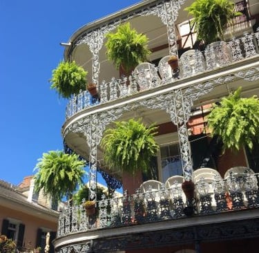 new orleans - a building with a balcony and a balcony with plants