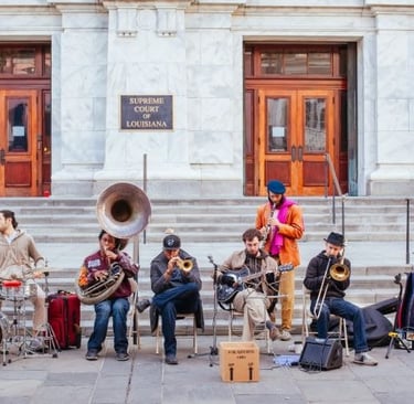 a group of musicians playing instruments in front of a building  in New Orleans