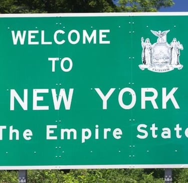 a green sign that says welcome to new york