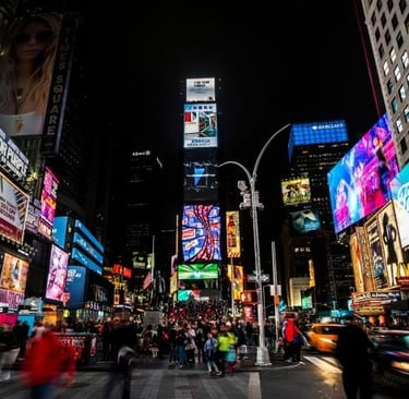 a busy intersection in new york city at night