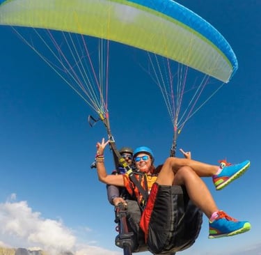 a man and woman parasailing in a parachute