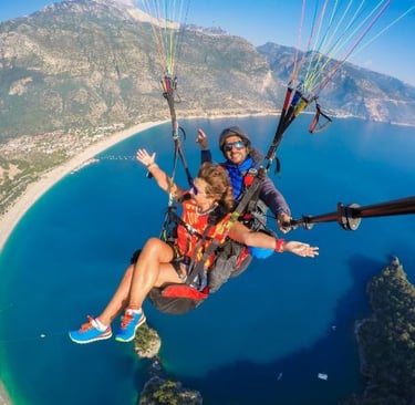 a couple parasailing over a body of water