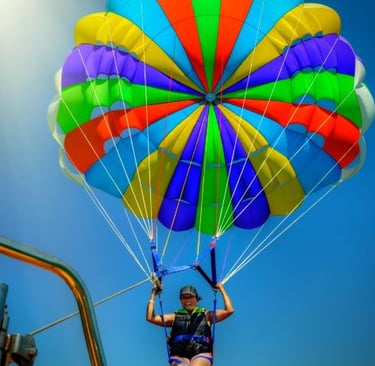 a person parasailing on a parachute