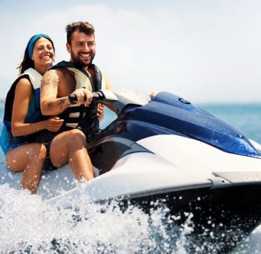 a man and woman riding a jet skis
