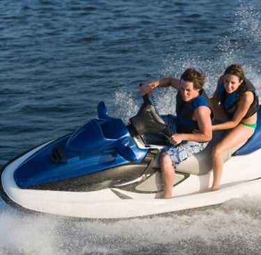 a man and woman riding a jet skis