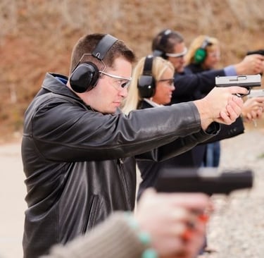 a man in a leather jacket and earphones on a shooting range