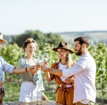 a group of people standing around a table with wine glasses
