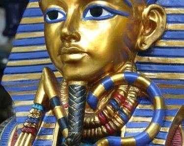 a golden statue of a pharaoh in a golden mask