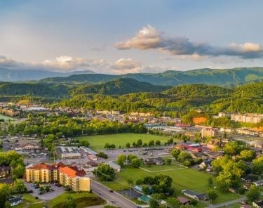 a cityscape of pigeon forge with mountains in the background
