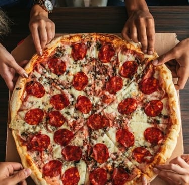a pizza with pepperonini pizza on a table