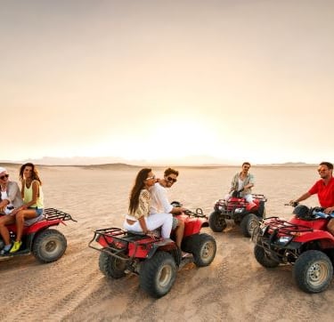 quad bikie - a group of people riding on four wheelers