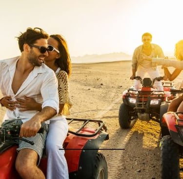 Quad Bike - a man and woman riding on four wheelers