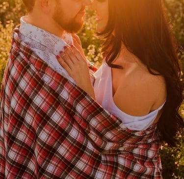 a man and woman standing in a field