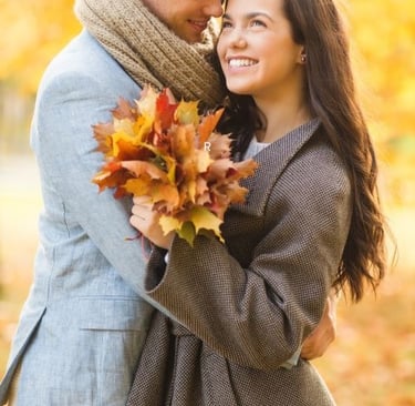 a man and woman embracing in autumn