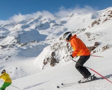 two people skiing down a mountain slope