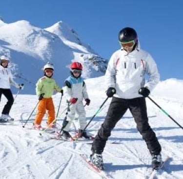 a group of people skiing down a mountain