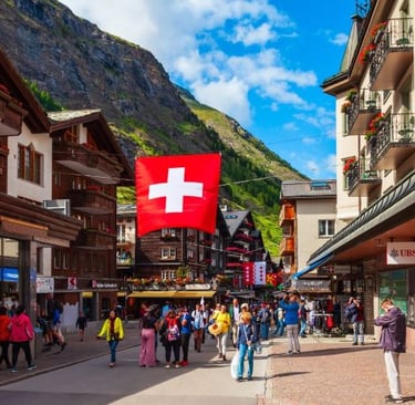 a group of people walking down a street with a swiss flag
