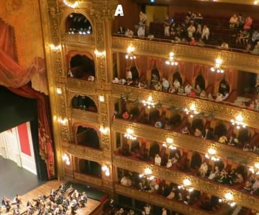 a large auditorium with a large audience watching a performance