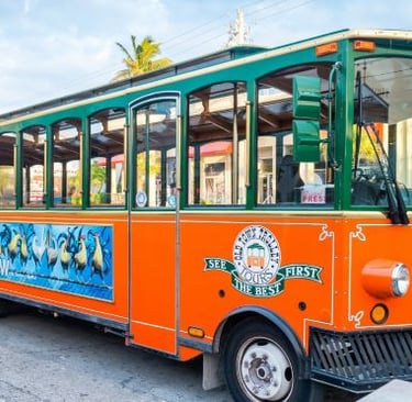 a trolley bus with a colorful bus on the side