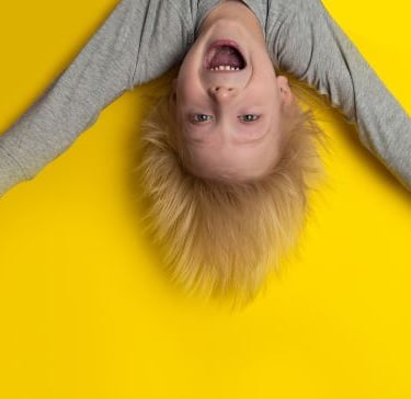 a young boy upside down