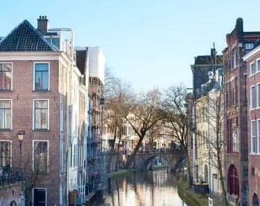 a canal with a boat  in a canal in utrecht