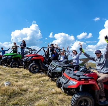 a group of people riding on four wheelers