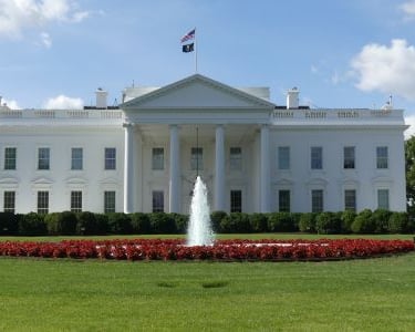 white house - a large white house with a fountain in front of it
