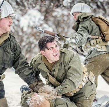 a man in a military uniform is holding a rifle