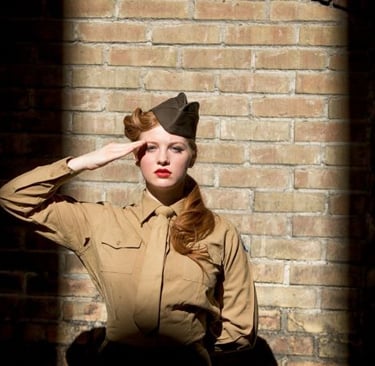 a woman in a military uniform is posing for a photo