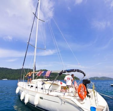 a sailboat in the water with a life preserver
