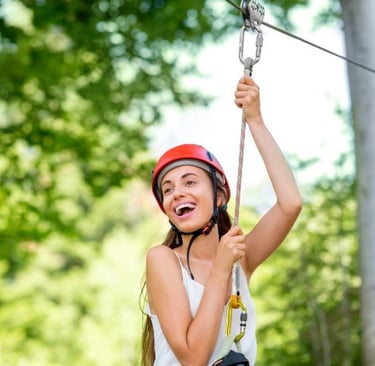 a woman in a helmet and helmet on a zip line