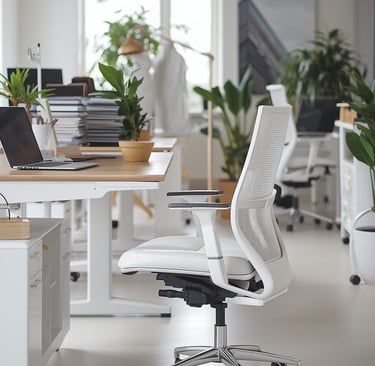 a white office chair with a laptop and a laptop