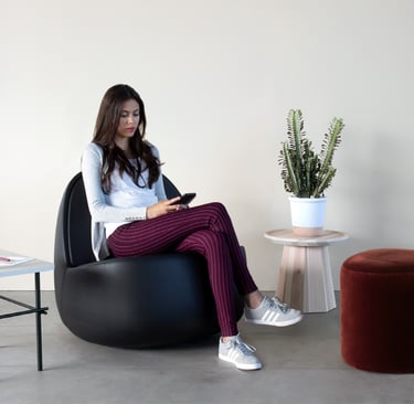 a woman sitting on a bean bag chair